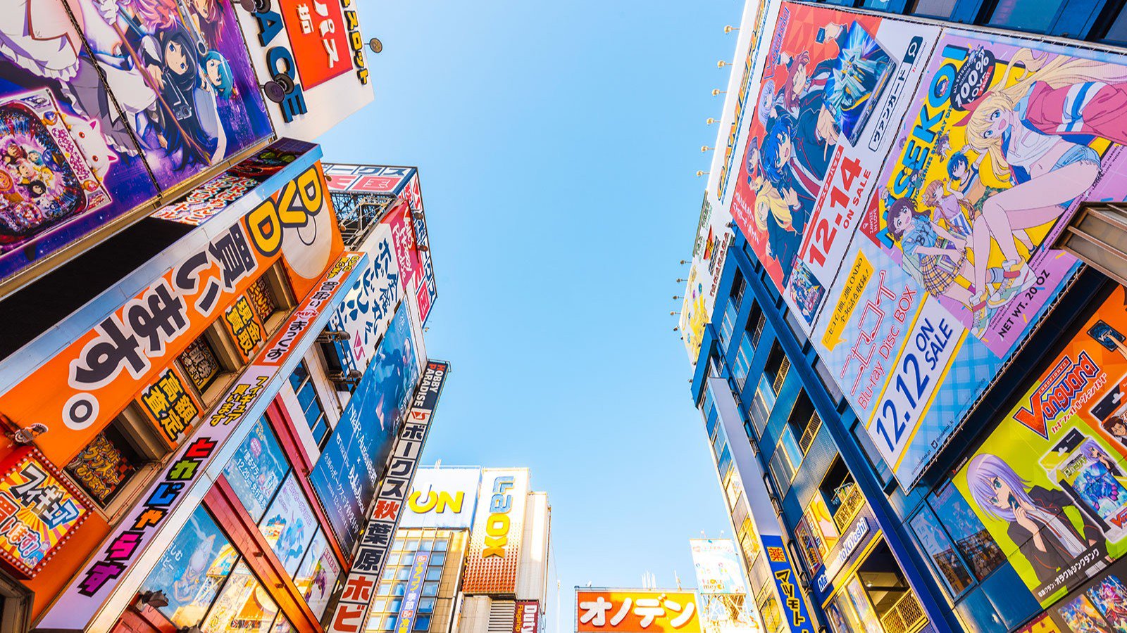 In den Himmel fotografierte Häuserfassaden einer Geschäftsstraße in Tokio | © Studiosus