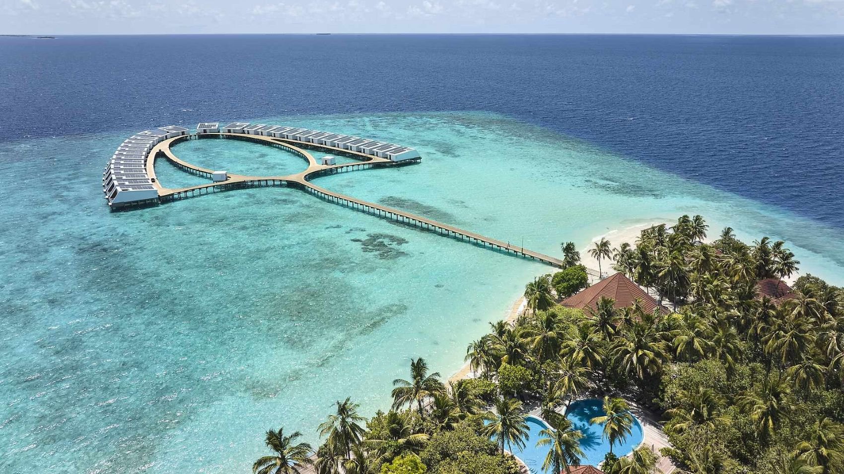 Luftaufnahme eines Abschnitts des ROBINSON MALDIVES mit Poollandschaft, Strand und Palmen | © ROBINSON